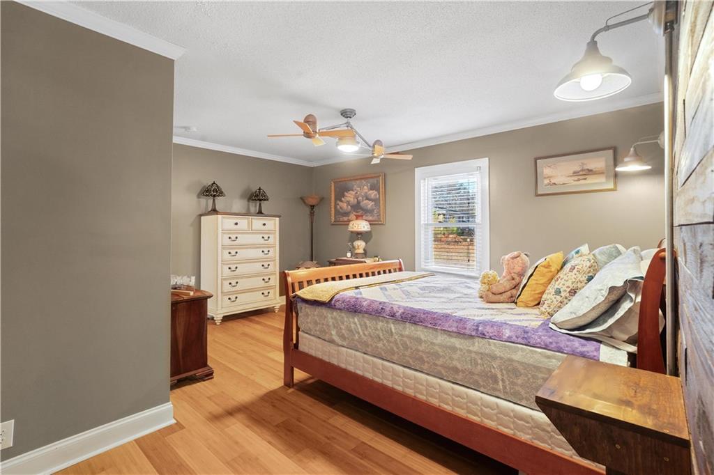 297 Tucker Hollow Road Southeast Calhoun, GA 30701 - Photo 17 of 42 a bedroom with a bed and wooden floor