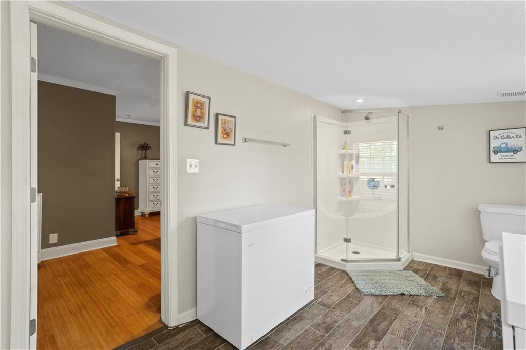297 Tucker Hollow Road Southeast Calhoun, GA 30701 - Photo 20 of 42 a view of a hallway with bathroom and wooden floor
