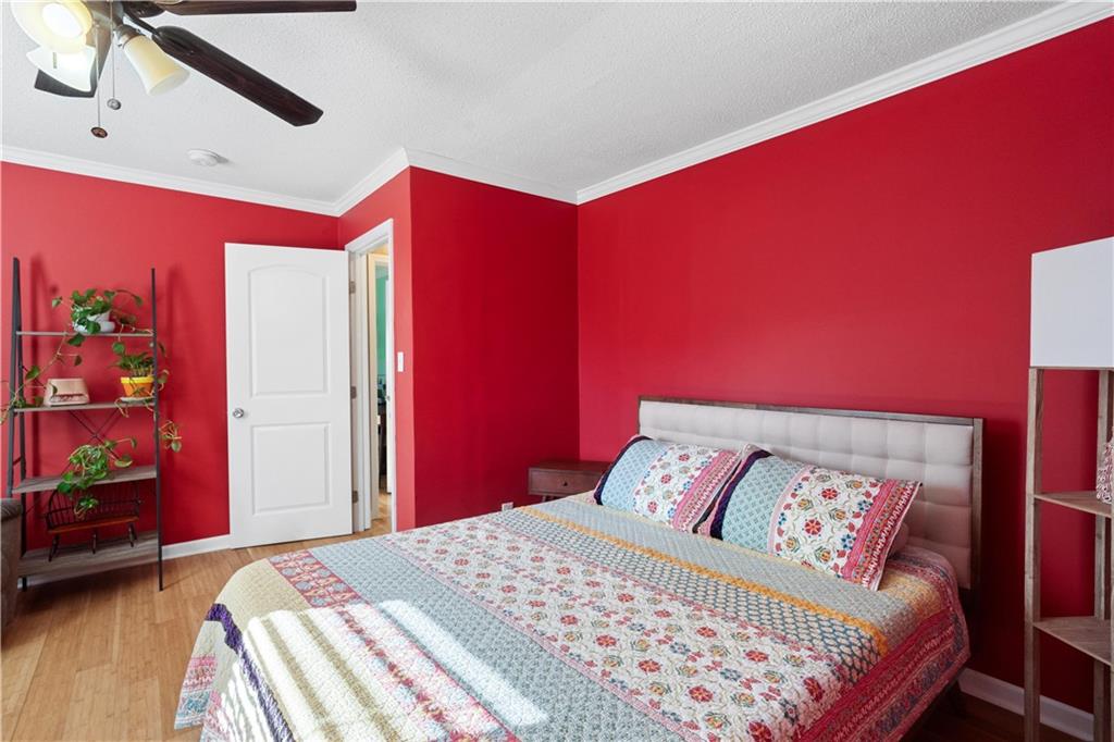 297 Tucker Hollow Road Southeast Calhoun, GA 30701 - Photo 24 of 42 a bedroom with a bed and a dresser with wooden floor