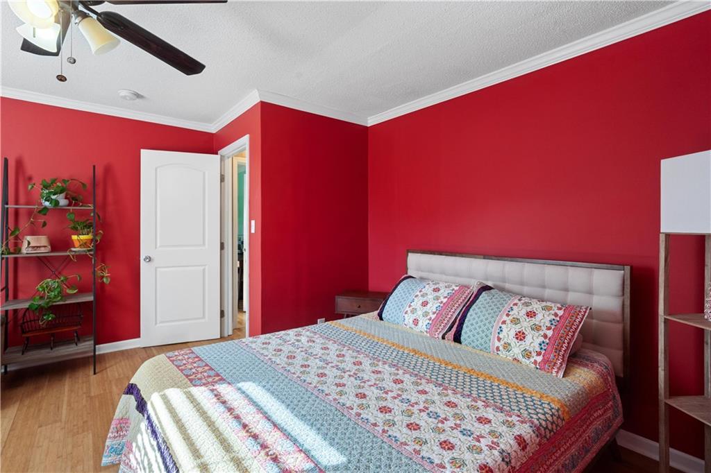 297 Tucker Hollow Road Southeast Calhoun, GA 30701 - Photo 25 of 42 a bedroom with a bed and a dresser with wooden floor