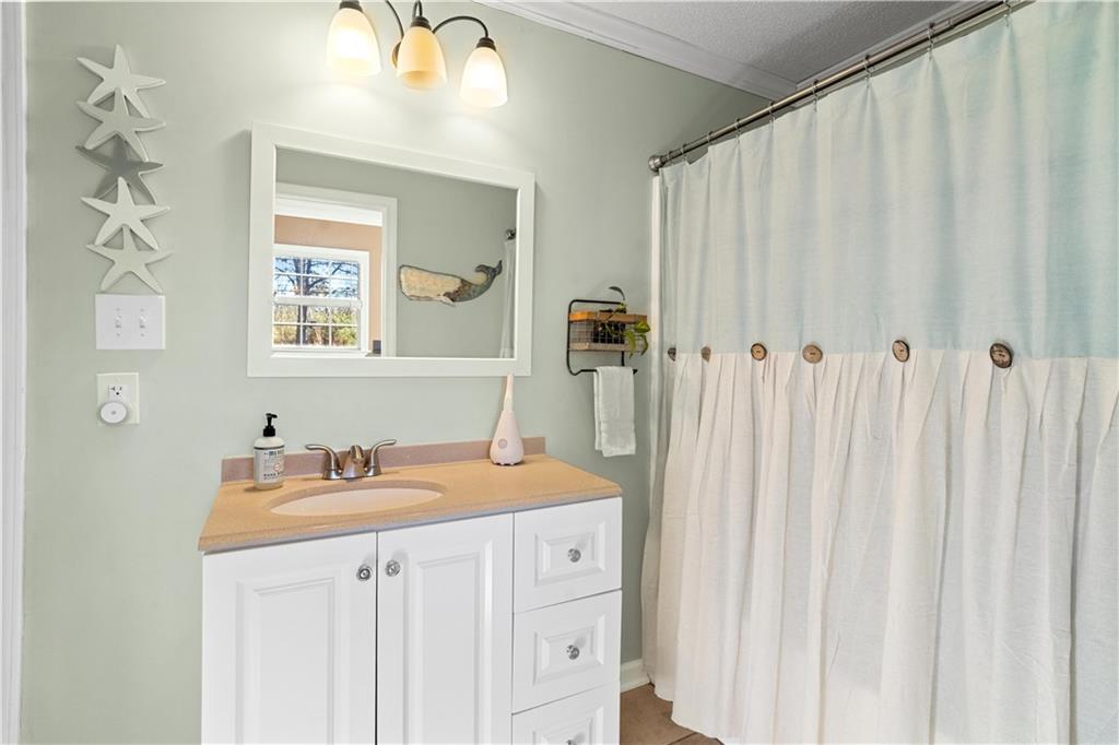 297 Tucker Hollow Road Southeast Calhoun, GA 30701 - Photo 27 of 42 a bathroom with a sink vanity and a mirror