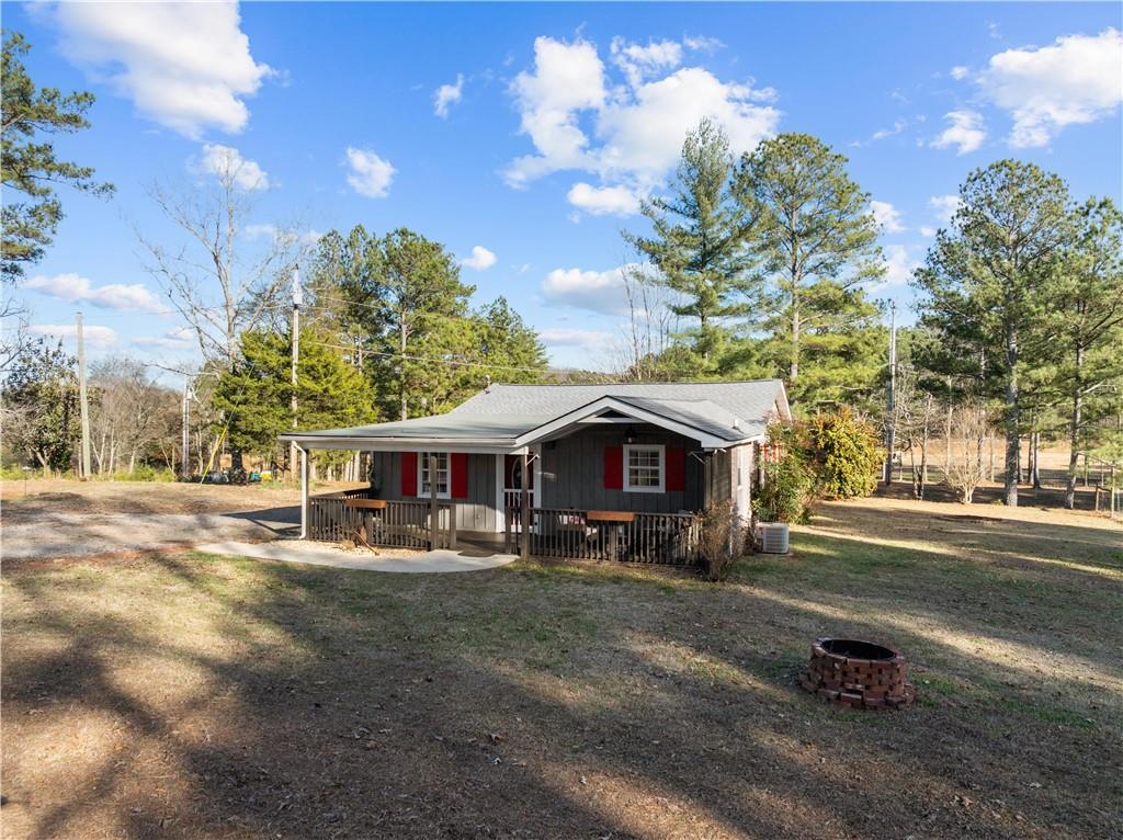 297 Tucker Hollow Road Southeast Calhoun, GA 30701 - Photo 3 of 42 a front view of a house with a yard