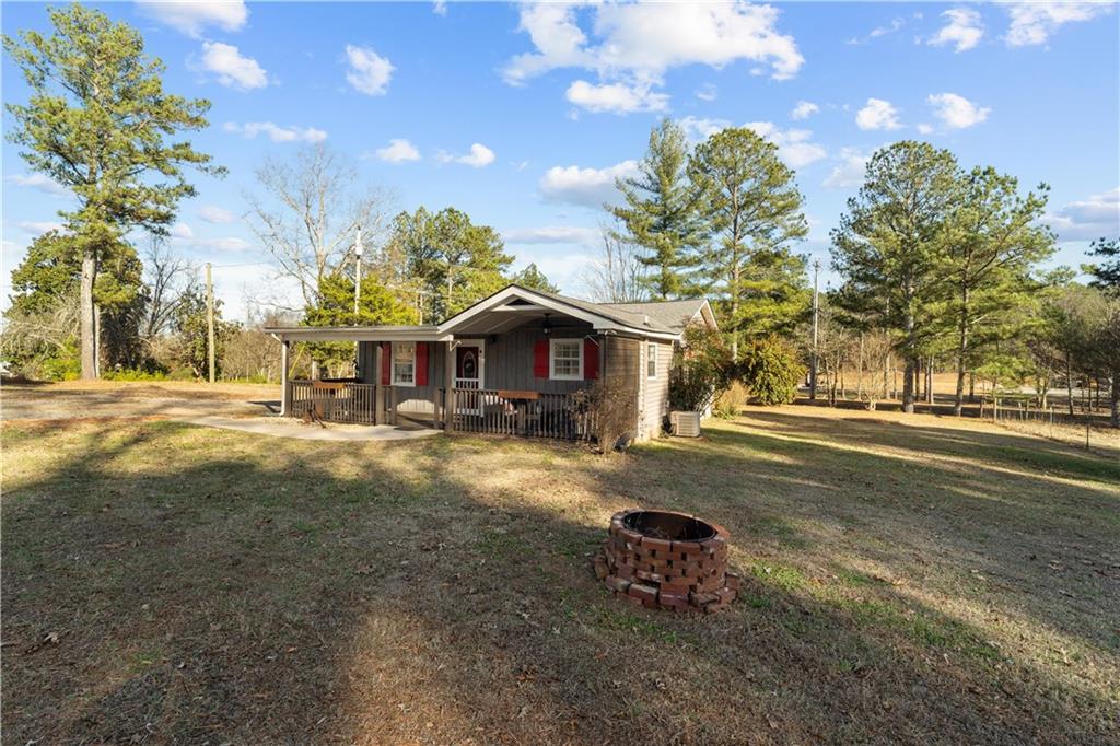 297 Tucker Hollow Road Southeast Calhoun, GA 30701 - Photo 32 of 42 a view of a house with a yard and sitting area