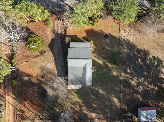 an aerial view of a house with a yard