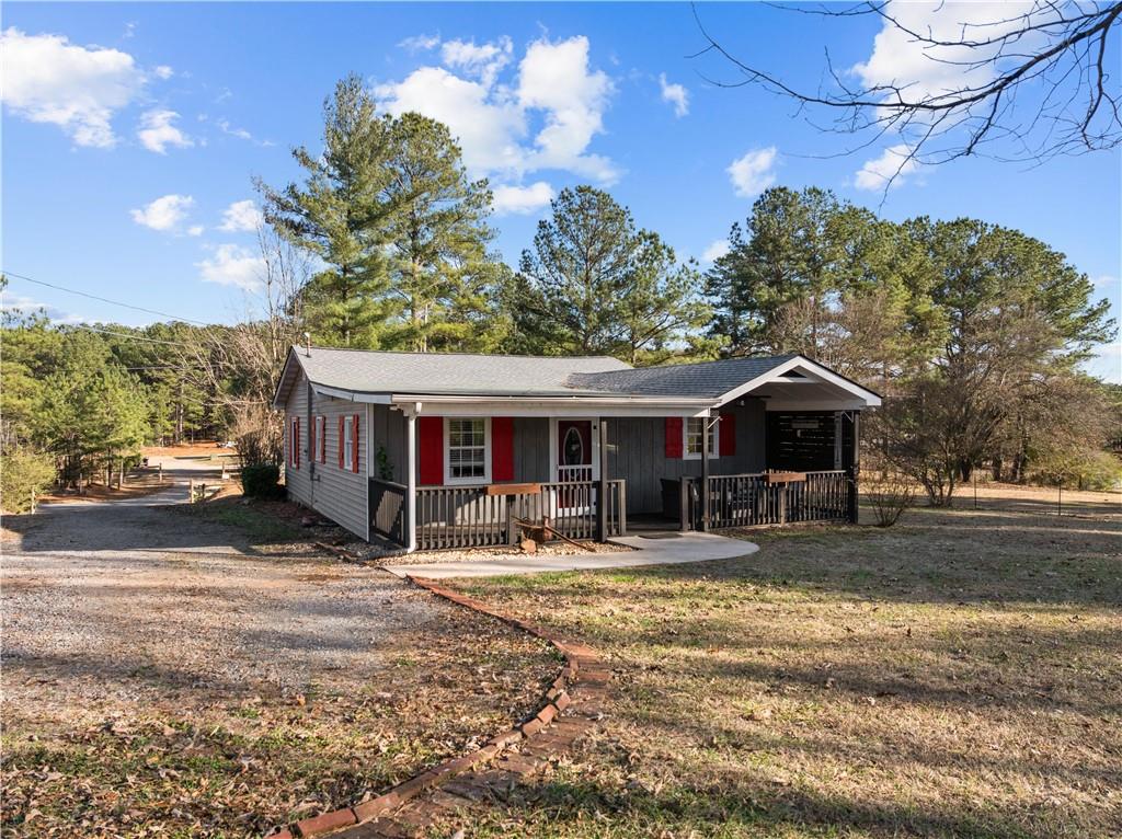 297 Tucker Hollow Road Southeast Calhoun, GA 30701 - Photo 39 of 42 a front view of a house with yard and seating area