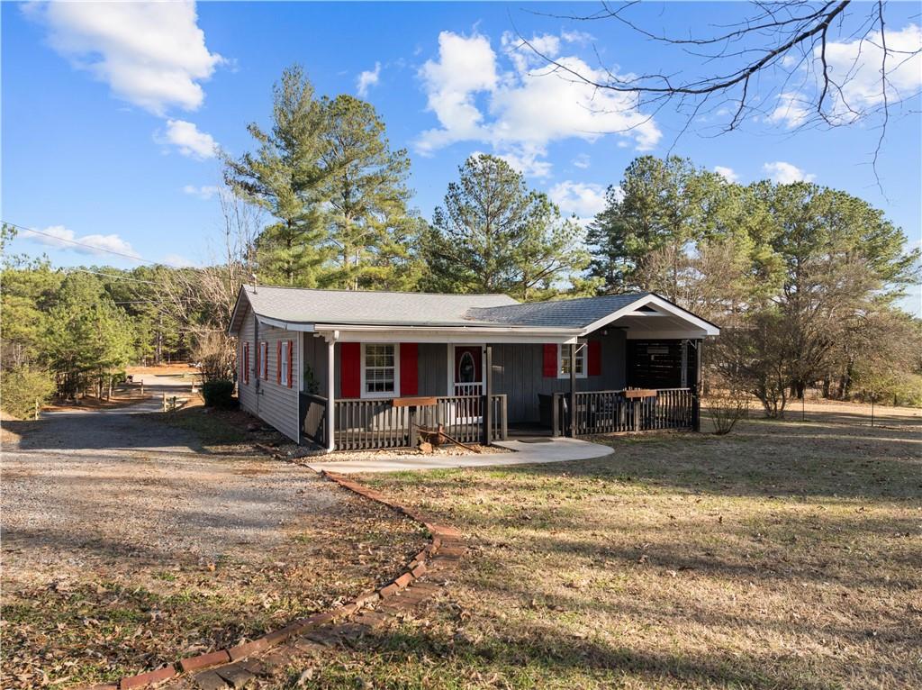 297 Tucker Hollow Road Southeast Calhoun, GA 30701 - Photo 40 of 42 a front view of a house with yard and seating area