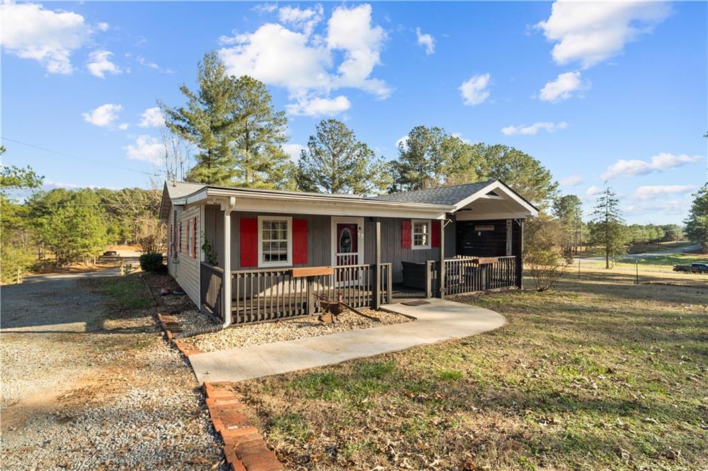 297 Tucker Hollow Road Southeast Calhoun, GA 30701 - Photo 41 of 42 a front view of house with outdoor seating and barbeque oven