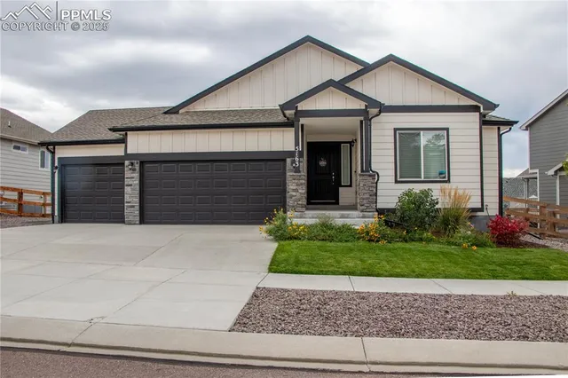 a view of a house with garage and garden