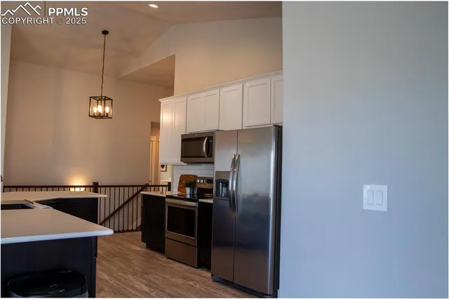 a kitchen with stainless steel appliances a refrigerator and a stove
