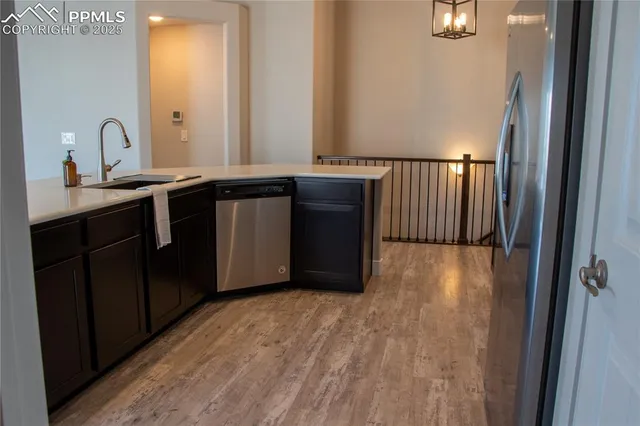 a kitchen with a refrigerator and a sink