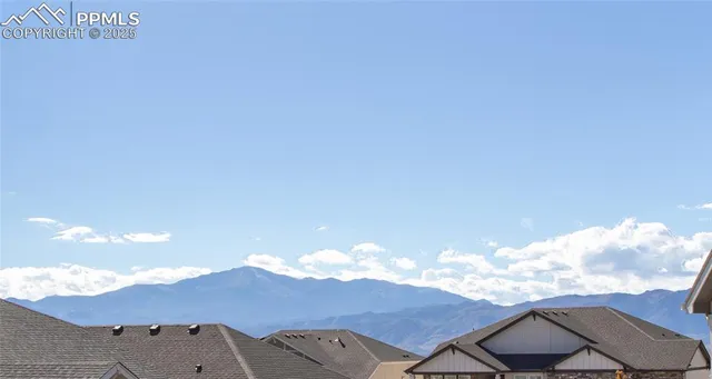 a view of a big house with a mountain in the background