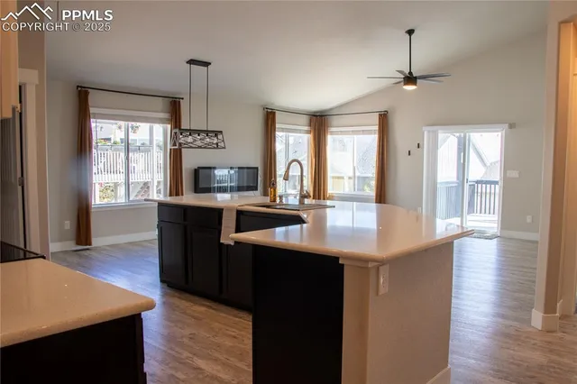 a kitchen with counter top space and windows