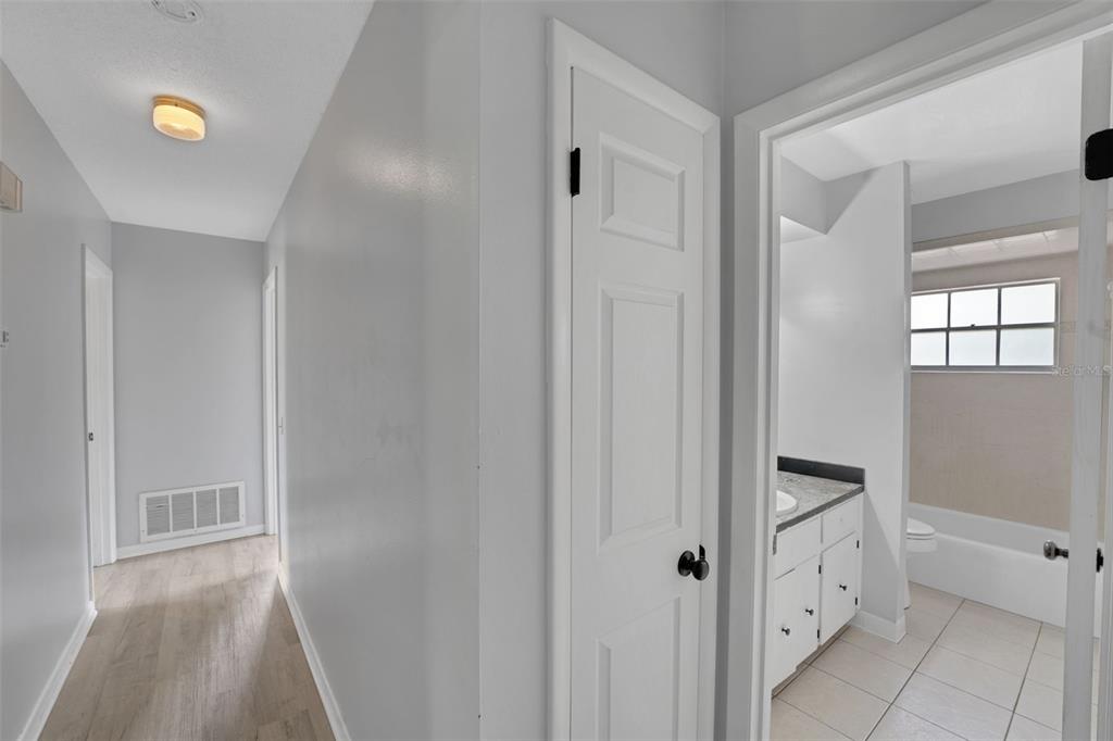 404 Lake Ned Road Winter Haven, FL 33884 - Photo 12 of 18 a bathroom with white cabinets and sink