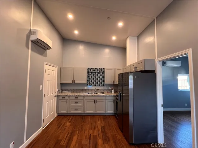 a kitchen with stainless steel appliances a refrigerator and a stove top oven