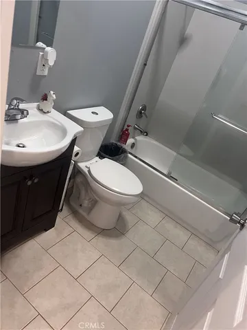a white toilet sitting next to a bathroom sink