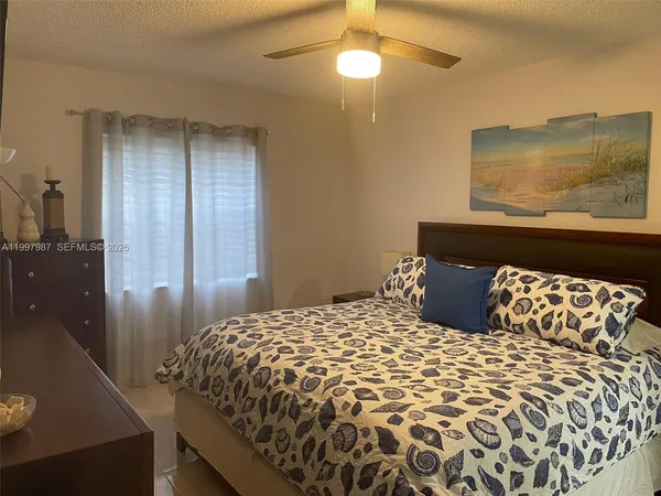 a bedroom with a large bed and a mirror