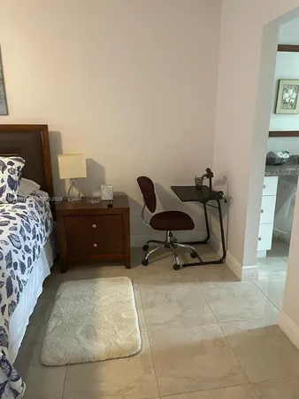 a bedroom with a bed and flat screen tv