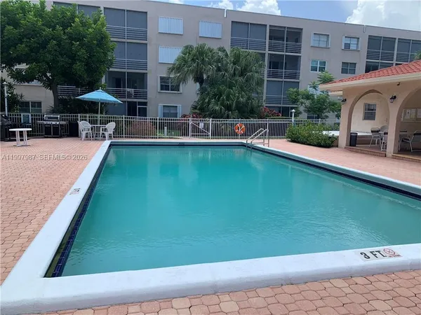 a view of a house with pool and a yard