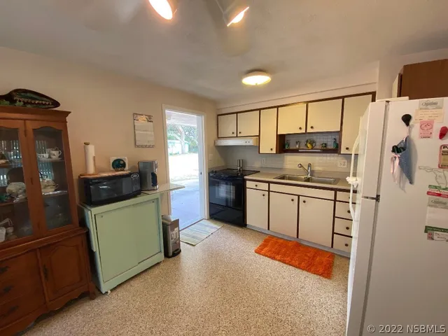 a kitchen with stainless steel appliances granite countertop a refrigerator and a stove