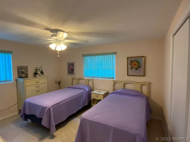 a bedroom with two beds and a chandelier