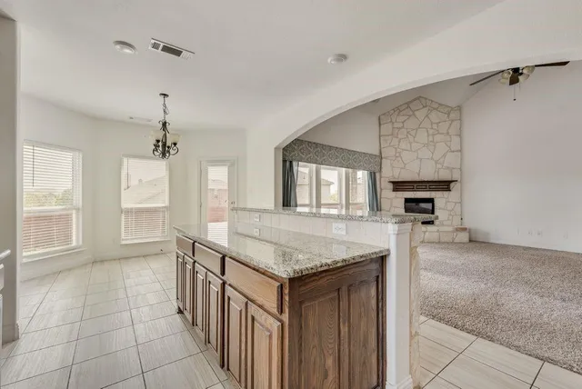 a bathroom with a granite countertop sink a mirror and a bathtub