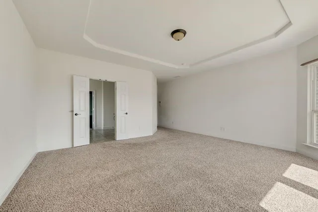 a spacious bathroom with a tub shower and mirror