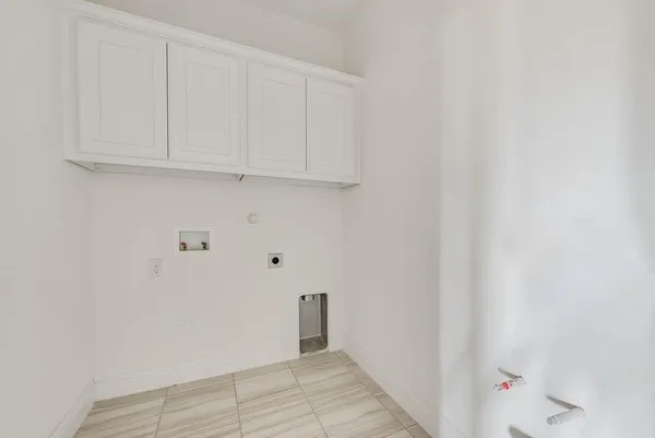an empty room with windows and cabinet