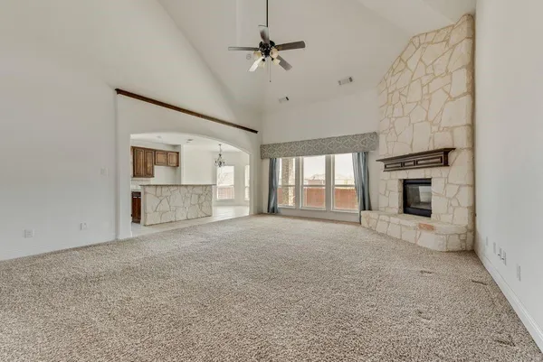 a view of a livingroom with a ceiling fan and staircase