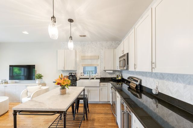a kitchen with a sink stove and cabinets