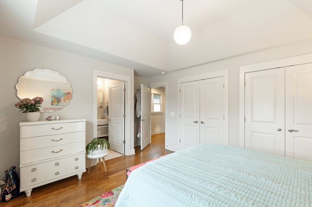 a bedroom with a bed and a dresser