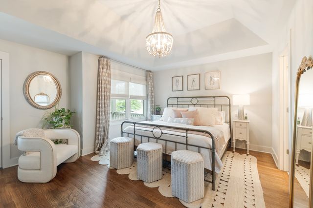 a bed room with a bed and a chandelier