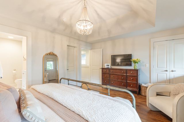 a bedroom with a bed and a chandelier