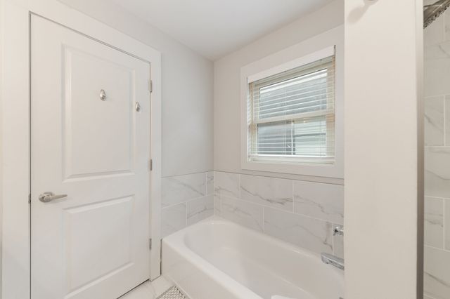 a white bath tub sitting next to a window