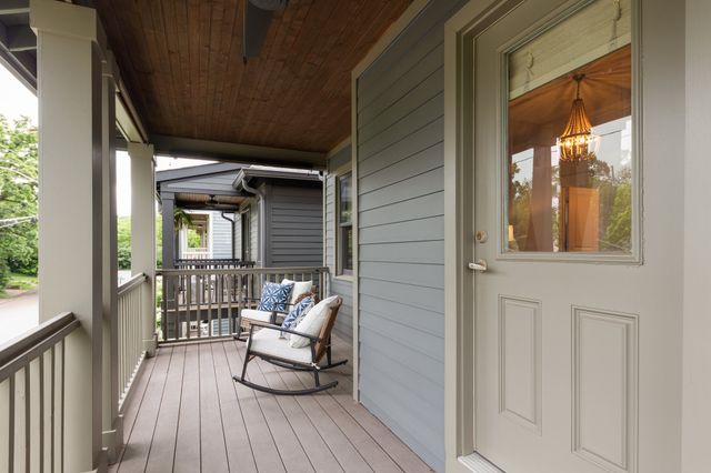 a balcony with furniture and wooden floor