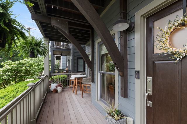 a patio with wooden floor and outdoor seating
