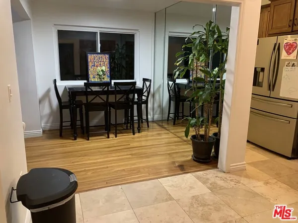 a view of a dining room with furniture and a potted plant