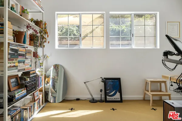 a view of a room with gym equipment and a window