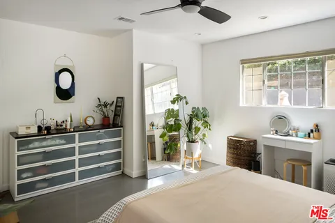a bedroom with bed and a window