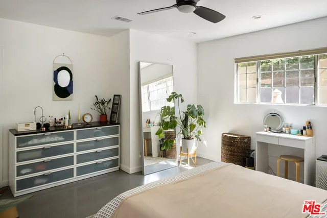 a bedroom with bed and a window