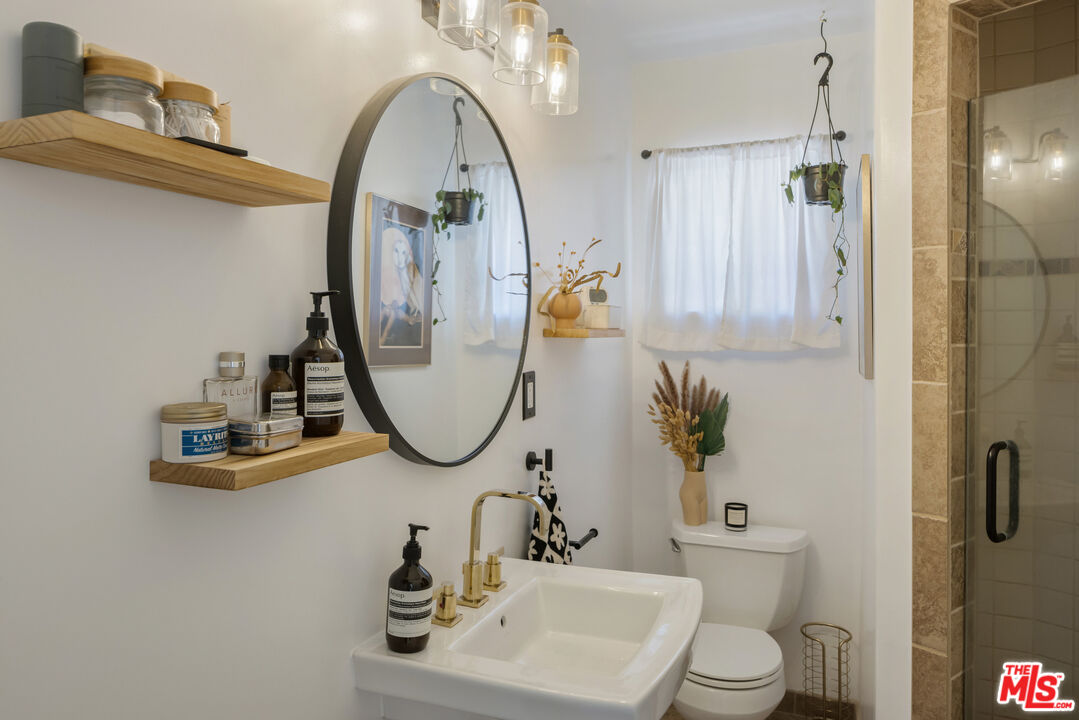 7815 Denivelle Road Sunland, CA 91040 - Photo 17 of 25 a bathroom with a sink a toilet and a mirror