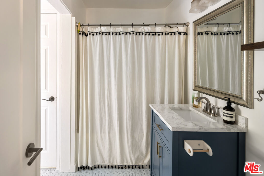 7815 Denivelle Road Sunland, CA 91040 - Photo 20 of 25 a bathroom with a granite countertop sink and a mirror