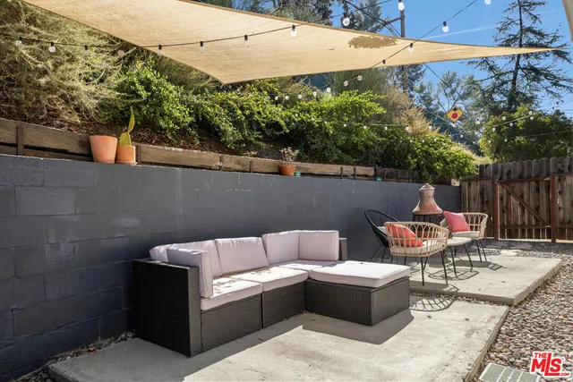 a backyard of a house with outdoor seating