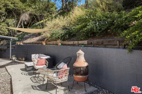 a view of a chairs and table in backyard