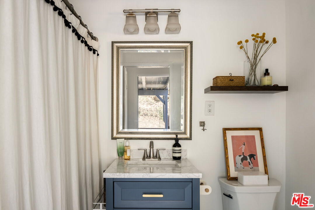 7815 Denivelle Road Sunland, CA 91040 - Photo 21 of 25 a bathroom with a sink and a mirror