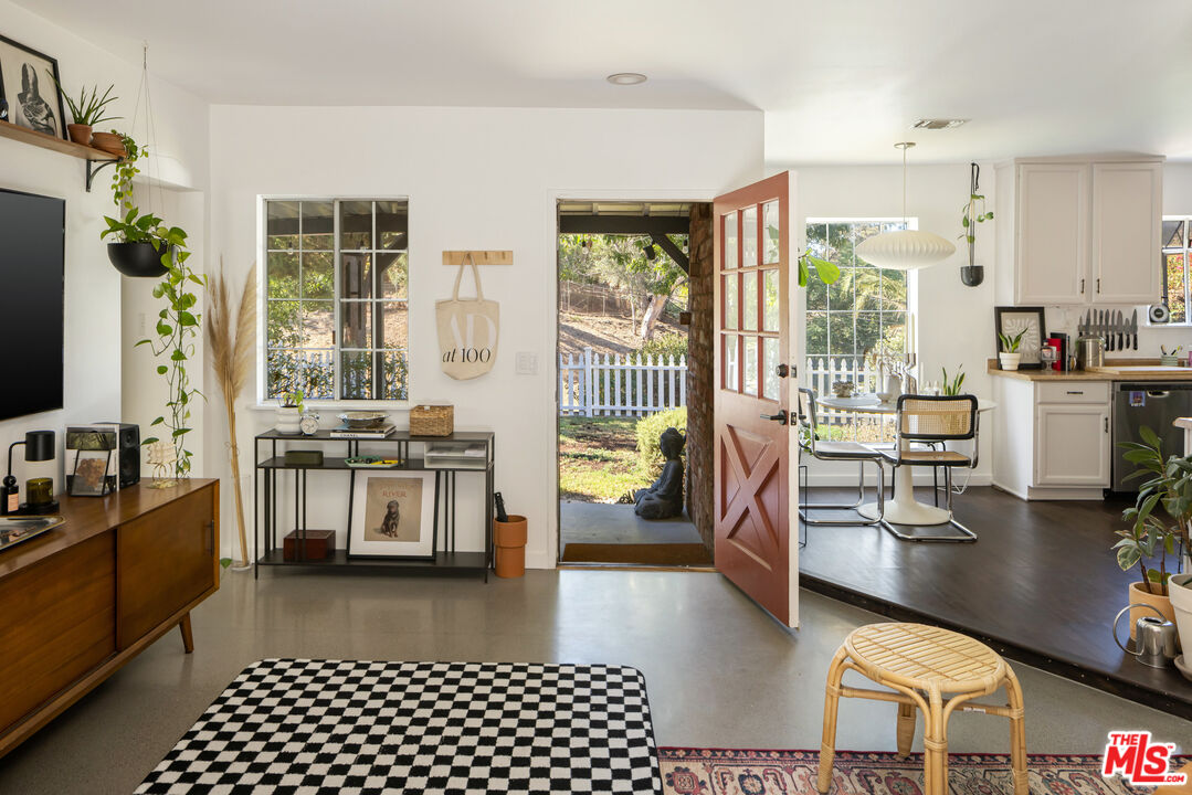 7815 Denivelle Road Sunland, CA 91040 - Photo 4 of 25 a living room with stainless steel appliances furniture a rug and a view of kitchen