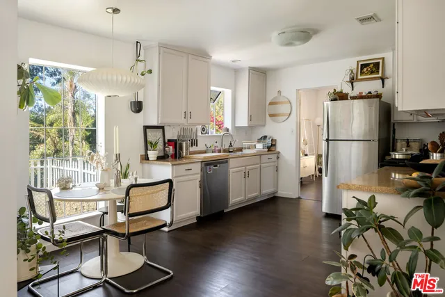 a kitchen with white cabinets and white appliances