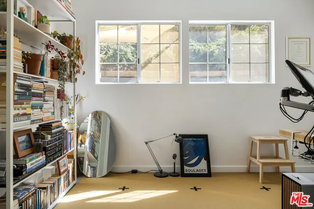a view of a room with gym equipment and a window