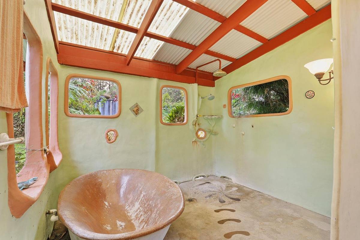 16-1585 Hopue Road, Unit 2 Mountain View, HI 96771 - Photo 17 of 29 a bathroom with a bathtub and shower