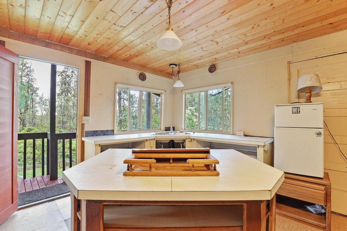 16-1585 Hopue Road, Unit 2 Mountain View, HI 96771 - Photo 22 of 29 a view of a dining room with furniture window and outside view