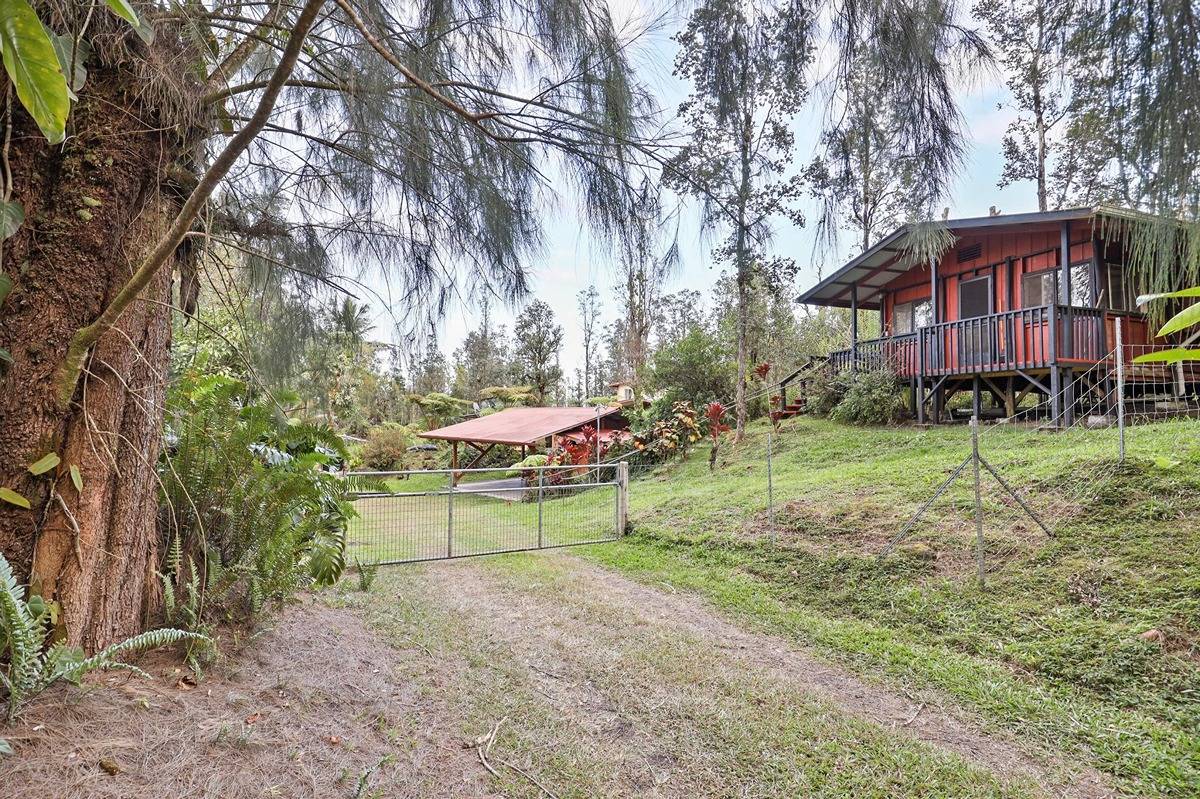 16-1585 Hopue Road, Unit 2 Mountain View, HI 96771 - Photo 3 of 29 a view of a house with a yard and sitting area